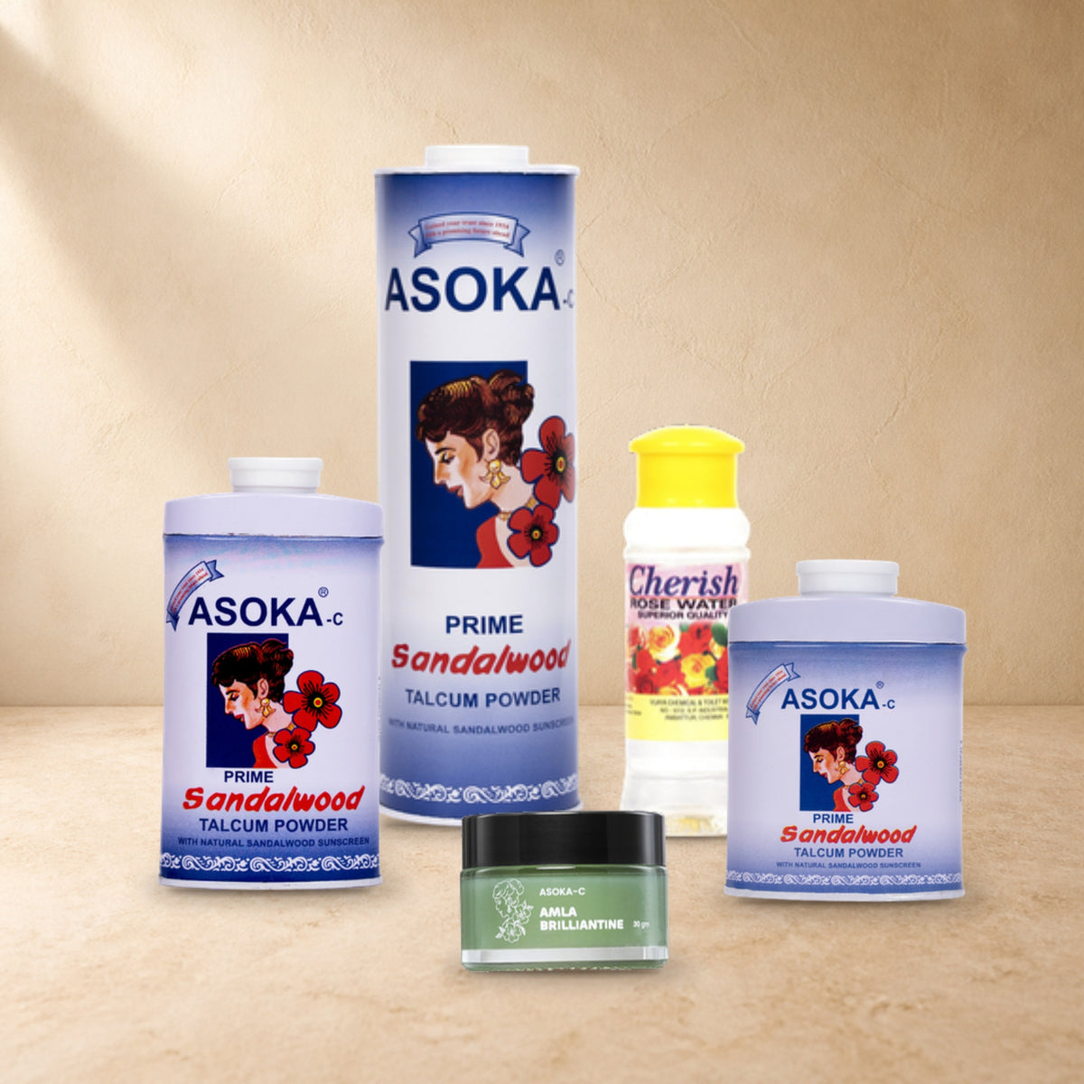 Asoka Ritual Set – Prime: Prime Sandalwood Talcum Powder 300g, 70g and 35g with Amla Brilliantine 30g and Cherish Rosewater 100ml, arranged on a sandstone tabletop